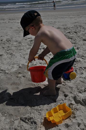 Jackson pouring water on the sand